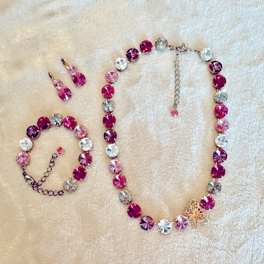 Swarovski crystal rose gold necklace, bracelet, and earrings with pink stones.